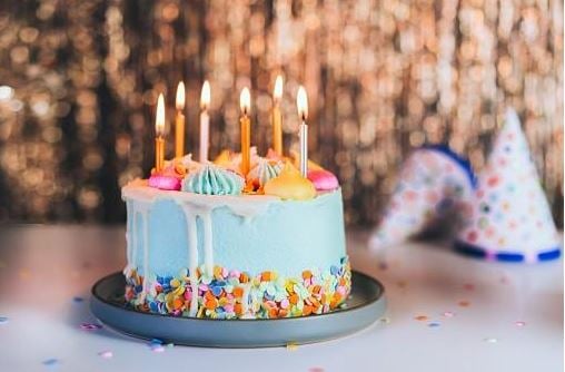 Blue birthday cake with candles