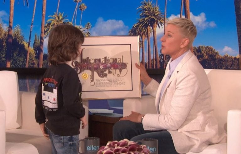Ellen DeGeneres giving a Star Registry package to young guest live on her show.
