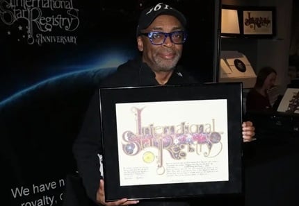 Image of Spike Lee holding his framed star gift for when he had a star named after him